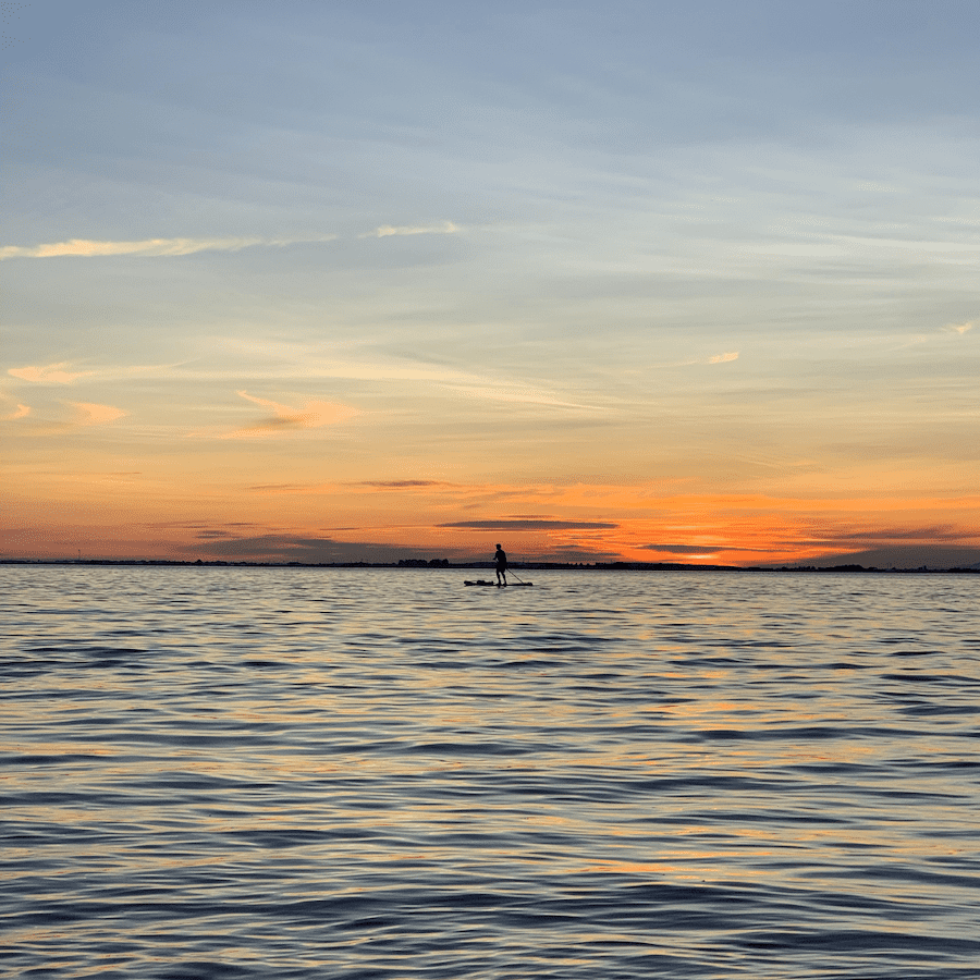 Paddle boarding in sunset